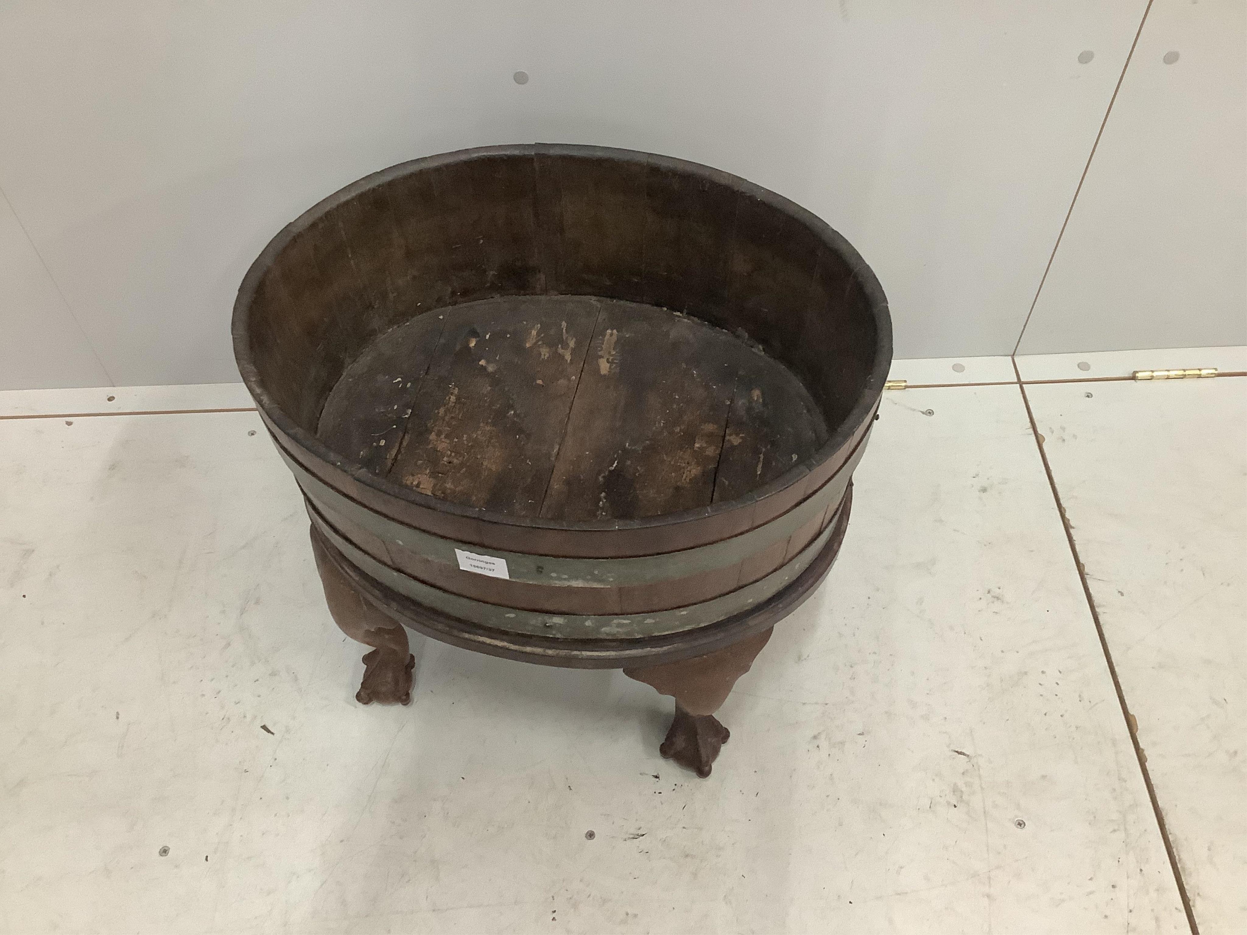 A George III oval brass bound mahogany wine cooler, width 54cm, depth 42cm, height 49cm. Condition - fair